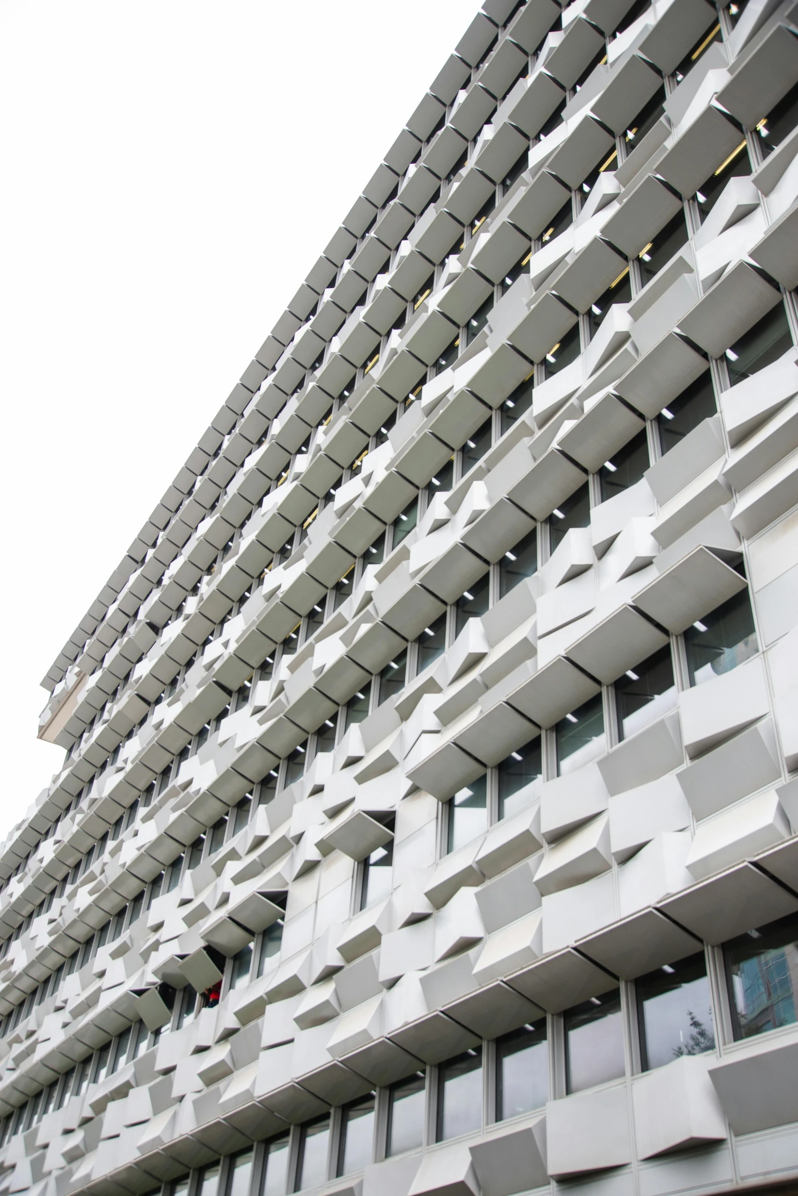 a very tall building with lots of windows, inspired by Ned M. Seidler, unsplash, brutalism, awnings, white panels, helsinki, in detail