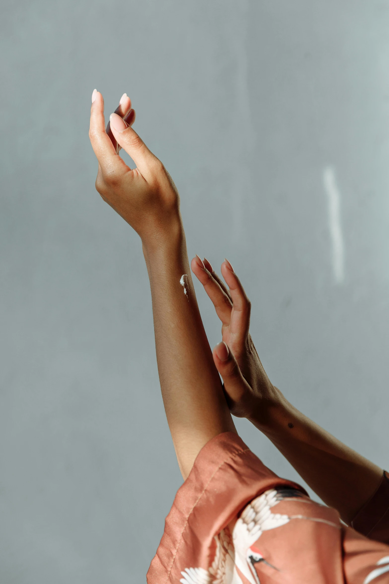 a woman holding a cell phone up to her ear, an album cover, by Matija Jama, trending on pexels, visual art, hands touching light drops, modern dance aesthetic, bandage on arms, soft shadow transition