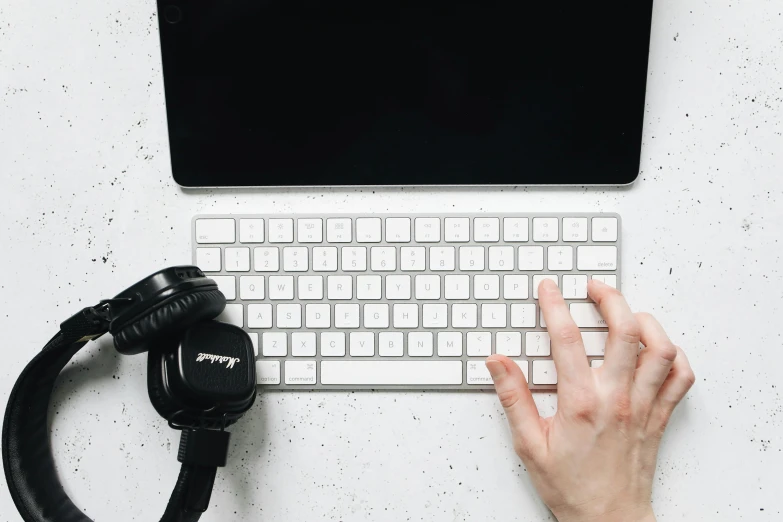a close up of a person typing on a keyboard, trending on pexels, with headphones, white minimalistic background, background image, flatlay