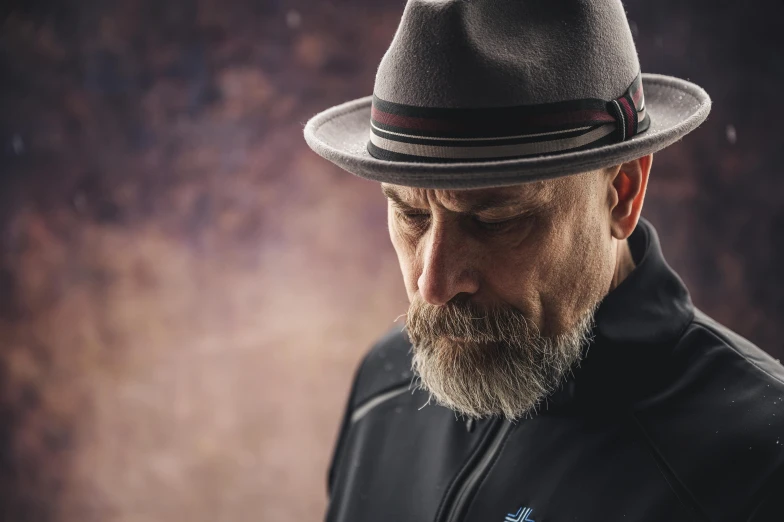 a man with a beard wearing a hat, inspired by George Pirie, unsplash, hyperrealism, wearing netrunner clothing, middle aged man, somber mood, tim booth