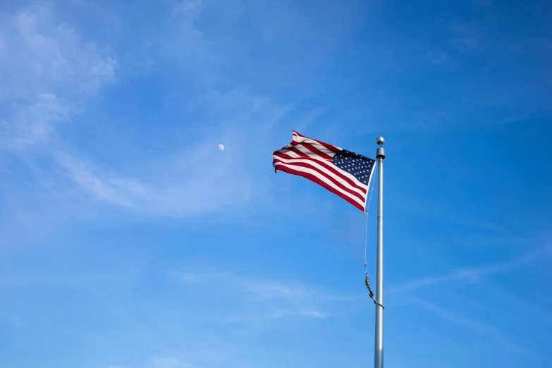 the american flag is flying high in the sky, a portrait, unsplash, hi resolution, multiple stories, low ultrawide shot, cloudless sky