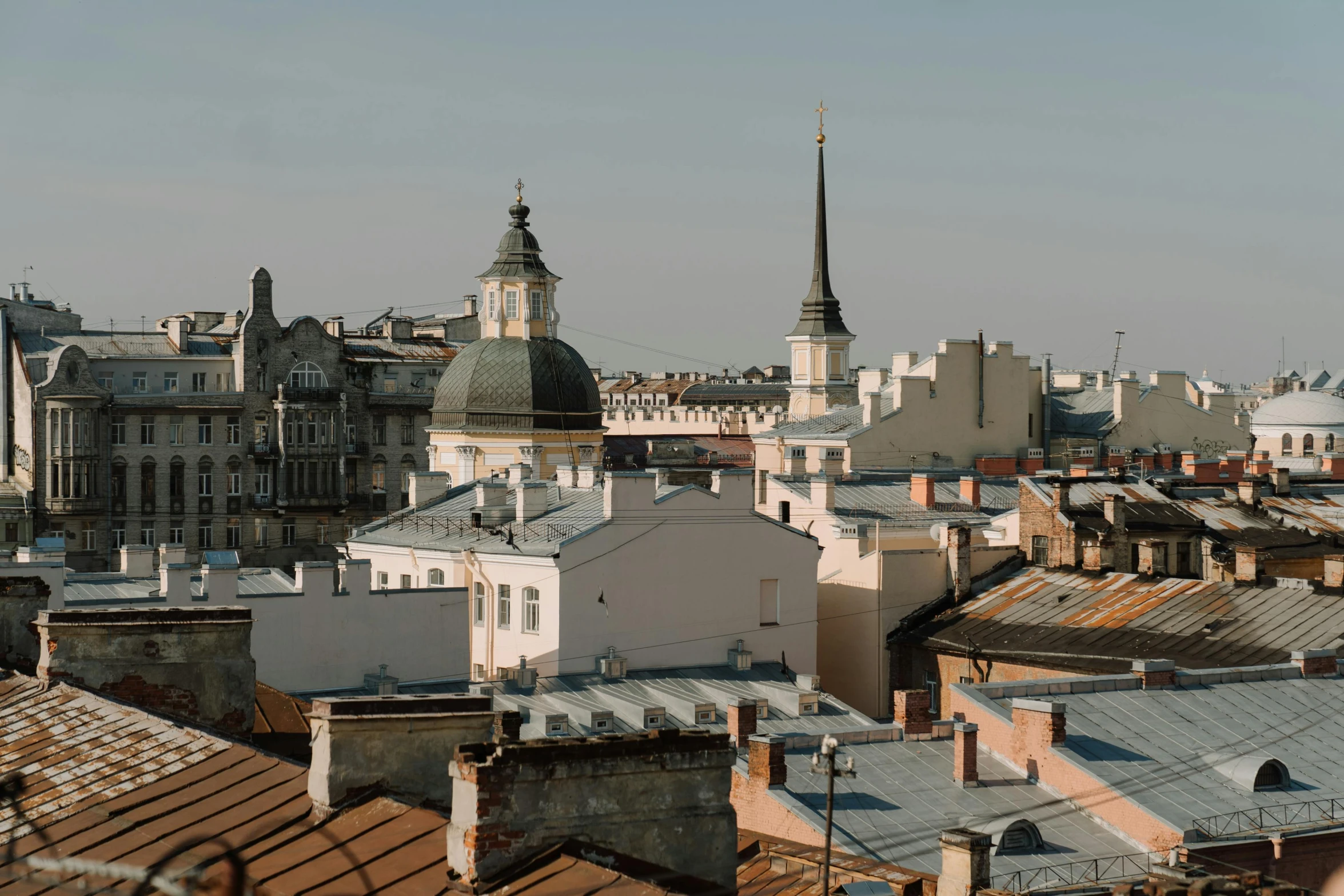a view of a city from the top of a building, by Emma Andijewska, pexels contest winner, baroque, rounded roof, neo kyiv, afternoon light, three views