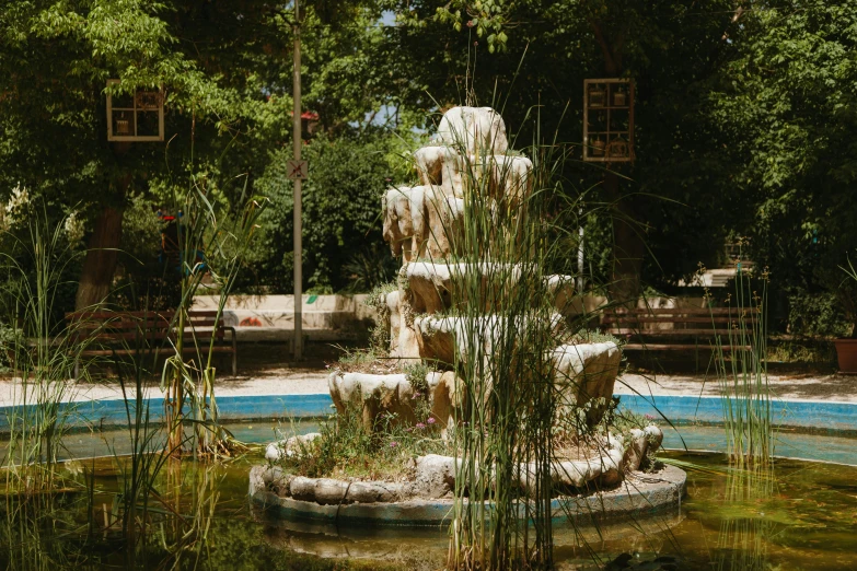 there is a fountain in the middle of a pond, inspired by Elsa Bleda, unsplash, les nabis, tehran, well shaded, tlaquepaque, 2 0 0 0's photo