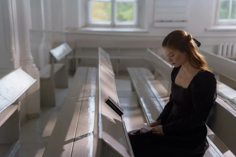 a woman sitting on a bench with a laptop, an album cover, pexels contest winner, renaissance, scene set in a church, eleanor tomlinson, hammershøi, high resolution movie still