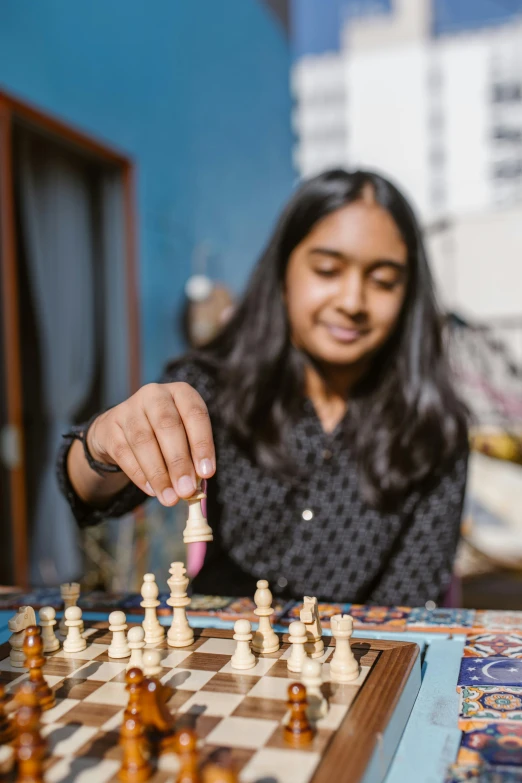 a man and a woman playing a game of chess, a portrait, trending on unsplash, indian girl with brown skin, 15081959 21121991 01012000 4k, 1 6 years old, full frame shot