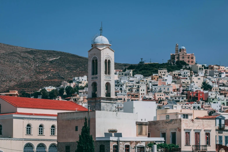 a view of a town with a clock tower, pexels contest winner, greek fabric, slightly tanned, thumbnail, square