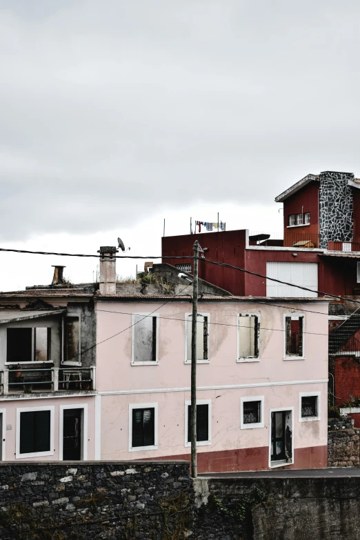 a couple of buildings that are next to each other, an album cover, by Lucia Peka, unsplash, quito school, “derelict architecture buildings, payne's grey and venetian red, on rooftop, in 2 0 1 2