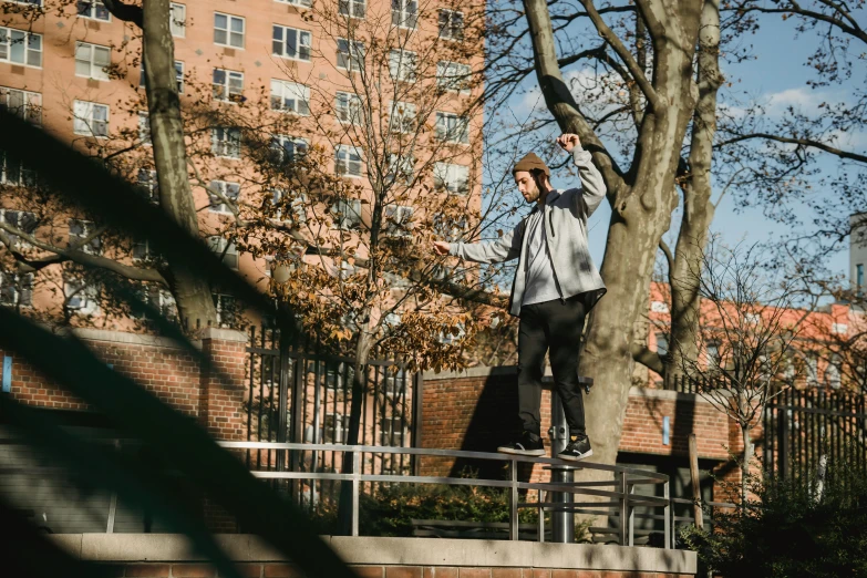 a man flying through the air while riding a skateboard, by Niko Henrichon, unsplash, lush brooklyn urban landscaping, sitting on a tree, [ cinematic, slide show