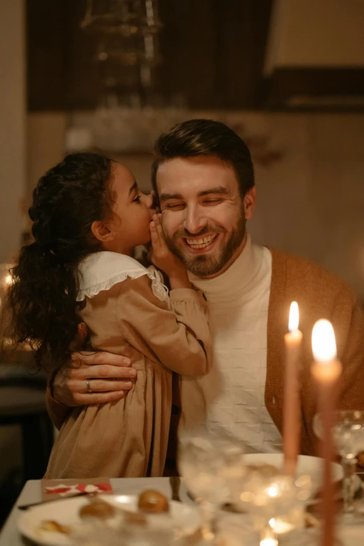 a man and a little girl sitting at a dinner table, pexels contest winner, romanticism, hugs, lit candles, handsome man, caucasian