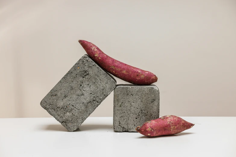 a pile of red potatoes sitting on top of cement blocks, an abstract sculpture, inspired by Sarah Lucas, concrete art, sangsoo jeong, pepper no. 3 5, miniature product photo, - photorealistic