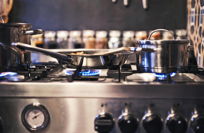 a stove top with pots and pans on it, pexels contest winner, michelin starred restaurant, thumbnail, looking left, steel