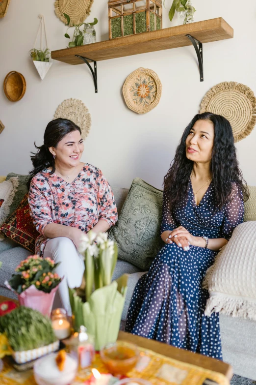 two women sitting on a couch in a living room, a portrait, by Mardi Barrie, pexels, ruan jia and brom, justina blakeney, profile image, ayanamikodon and irakli nadar