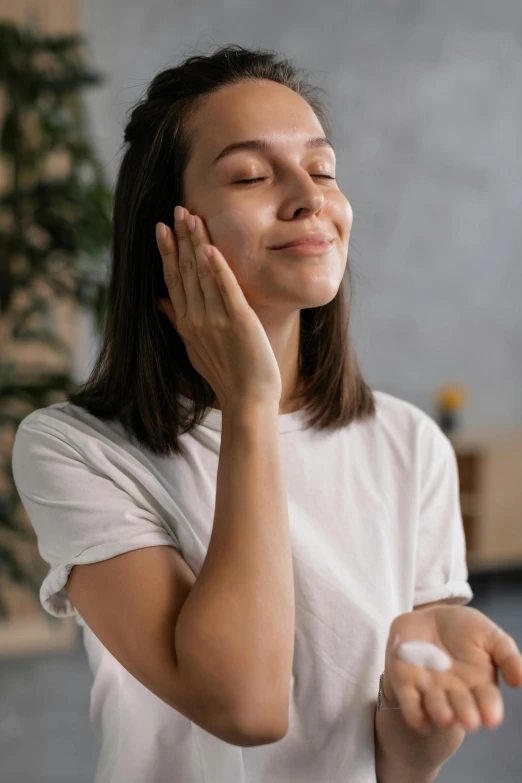 a woman is putting cream on her face, trending on pexels, renaissance, soft light from the side, smiling slightly, profile image, sweaty face