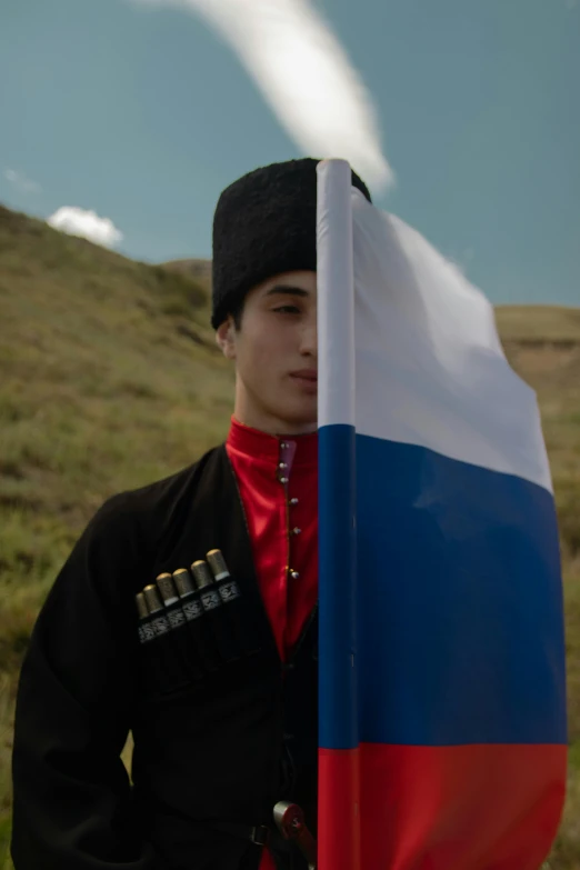 a man in a military uniform holding a russian flag, an album cover, unsplash, renaissance, in the hillside, cai xukun, ignant, nekro petros afshar