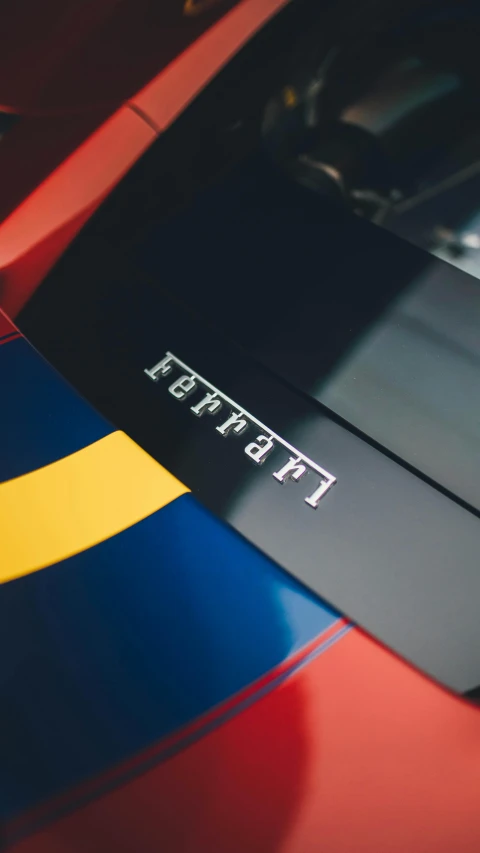 a close up of the hood of a red sports car, inspired by Petros Afshar, trending on unsplash, red yellow blue, medium format, thumbnail, behance lemanoosh