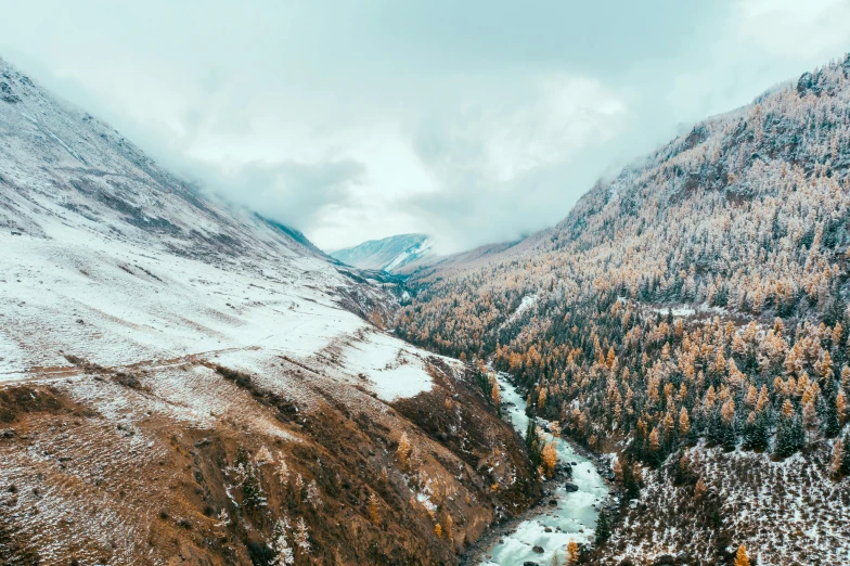 a river running through a snow covered valley, a photo, pexels contest winner, autumn, ultrawide angle cinematic view, instagram post, 4k image”