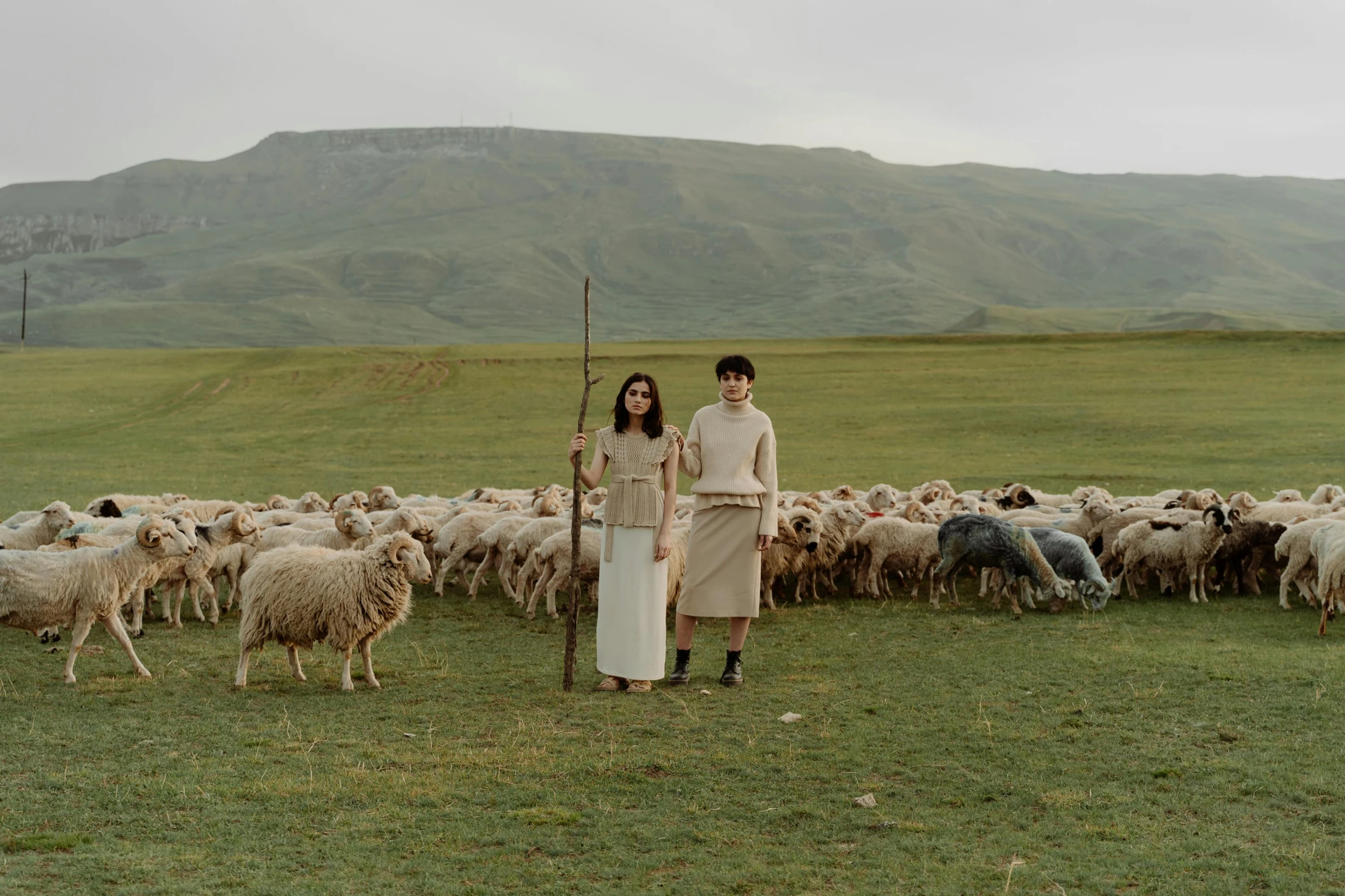 a man and a woman standing in front of a herd of sheep, an album cover, by Emma Andijewska, pexels contest winner, renaissance, ayanamikodon and irakli nadar, sangsoo jeong, still from film, highlands