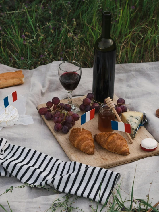 a table topped with food and a bottle of wine, inspired by Jules Bastien-Lepage, pexels contest winner, figuration libre, french flag, picnic, 15081959 21121991 01012000 4k, 35 mm product photo”