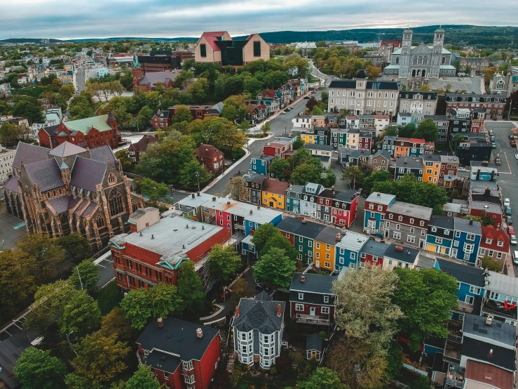 a view of a city from a bird's eye view, pexels contest winner, new england architecture, colorful scene, quebec, payne's grey and venetian red