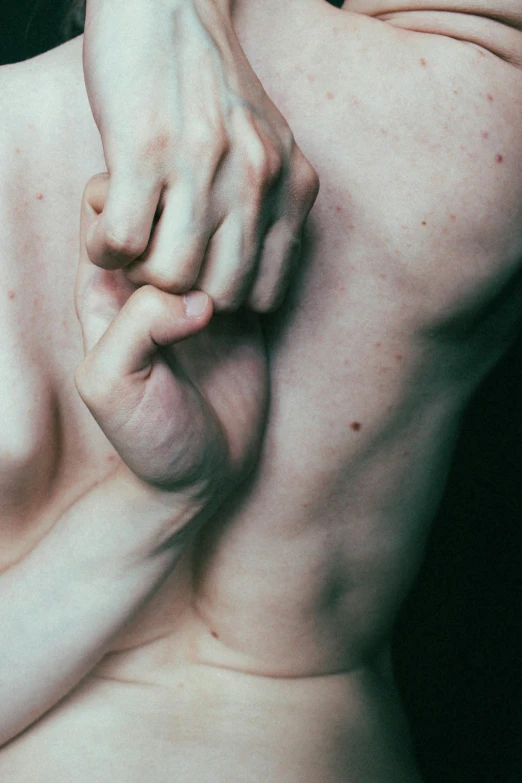 a close up of a person holding a cell phone, an album cover, inspired by Elsa Bleda, unsplash, renaissance, muscular bodies, extremely pale, holding each other hands, cysts