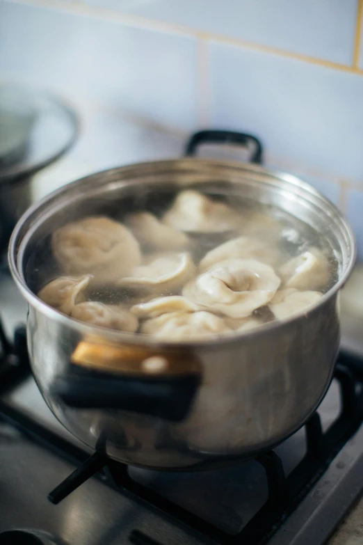 a pot filled with food sitting on top of a stove, bananas, straining, thumbnail, infused