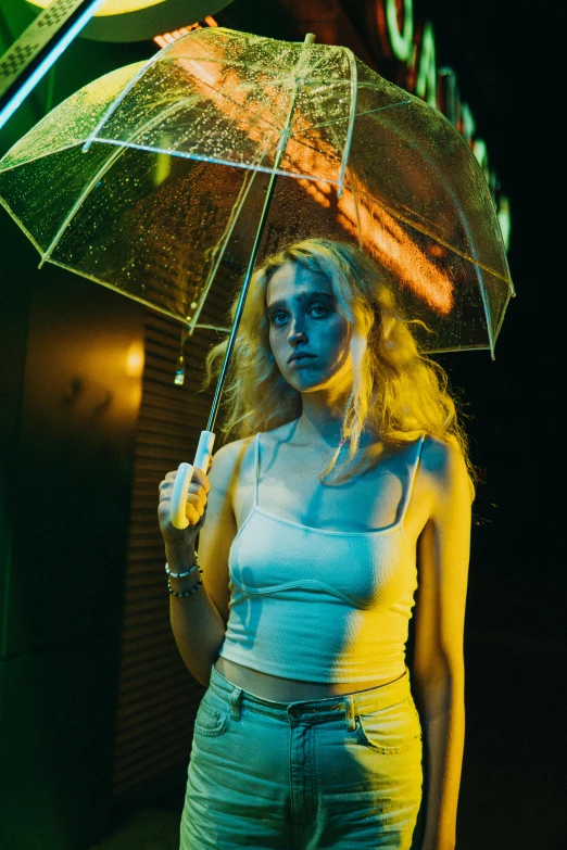 a woman holding an umbrella in front of a neon sign, inspired by Elsa Bleda, unsplash contest winner, photorealism, looks like a mix of grimes, young blonde woman, photo of a model, looking menacing