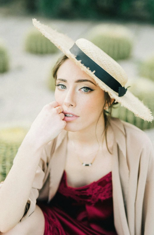 a woman sitting on a bench wearing a hat, a portrait, by Sara Saftleven, pexels, sydney sweeney, jewelry, wearing sombrero, poppy