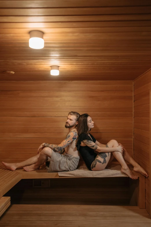 a man and a woman sitting on a bench in a sauna, a portrait, unsplash, anna nikonova aka newmilky, high-quality photo, square, panorama