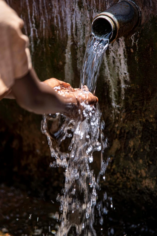a person is pouring water out of a pipe, trending on unsplash, unmistakably kenyan, slide show, full frame image, thumbnail