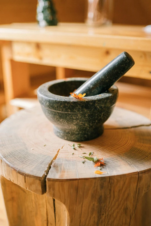 a mortar sitting on top of a wooden table, by Julia Pishtar, trending on pexels, herb, 15081959 21121991 01012000 4k, traditional beauty, grind