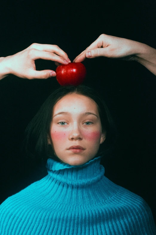 a woman holding an apple above her head, an album cover, inspired by Anna Füssli, trending on pexels, hyperrealism, jingna zhang, wearing turtleneck, complementary color, high school