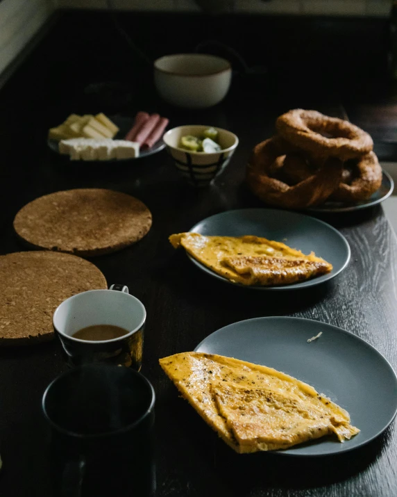 a table topped with plates of food next to a cup of coffee, unsplash, dau-al-set, with yellow cloths, kek, chuvabak, thumbnail