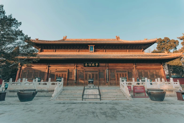 a building with a lot of steps in front of it, a picture, inspired by Xuande Emperor, pexels contest winner, peaceful wooden mansion, an altar of a temple, wide angle exterior 2022, baotou china