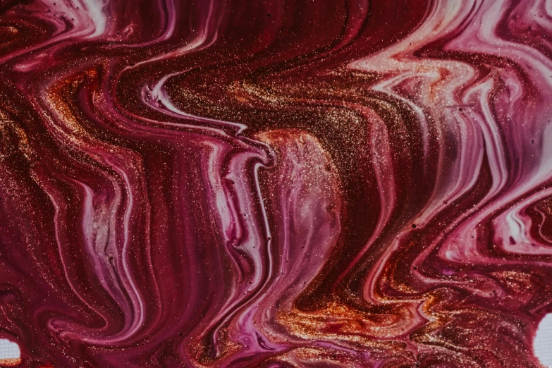 a close up of a liquid painting on a surface, by Sophie Pemberton, trending on pexels, maroon metallic accents, swirly, pink, unknown artist