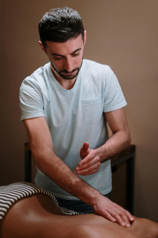 a man getting a massage in a room, sam nassour, corrected hand, square, thin young male