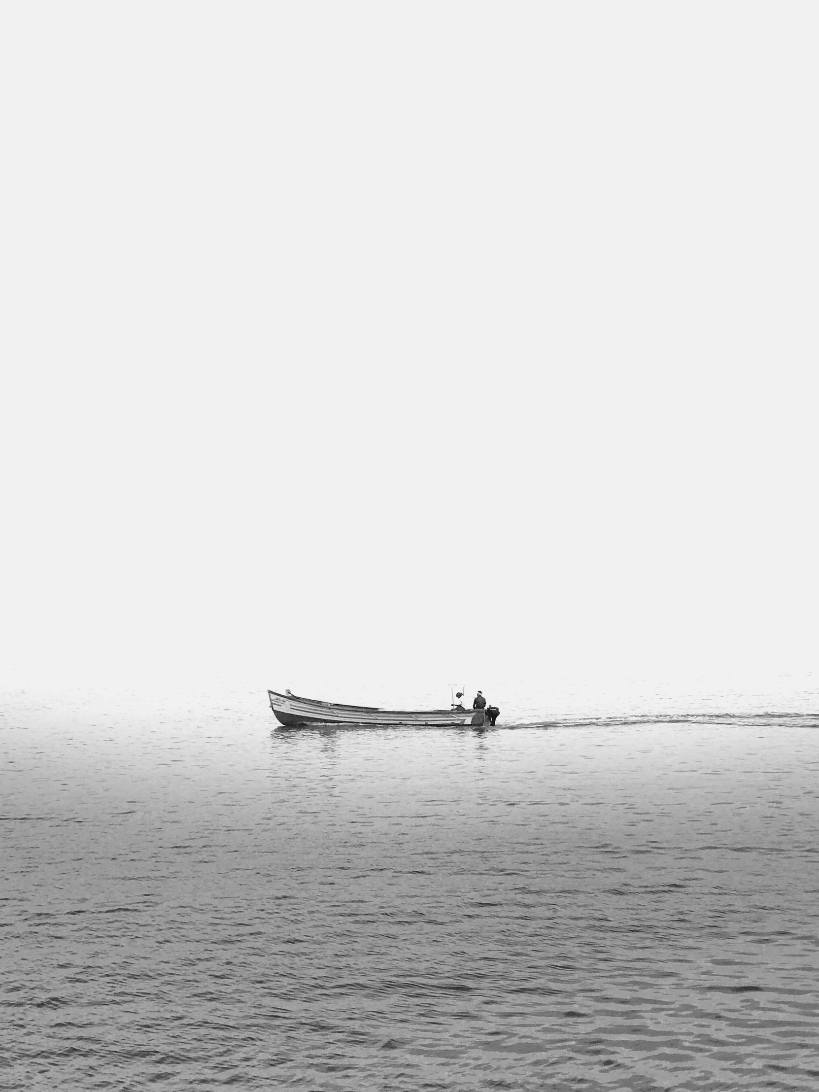 a boat floating on top of a body of water, a black and white photo, by Niyazi Selimoglu, minimalism, 2 5 6 x 2 5 6, fisherman, white fog, kyza saleem