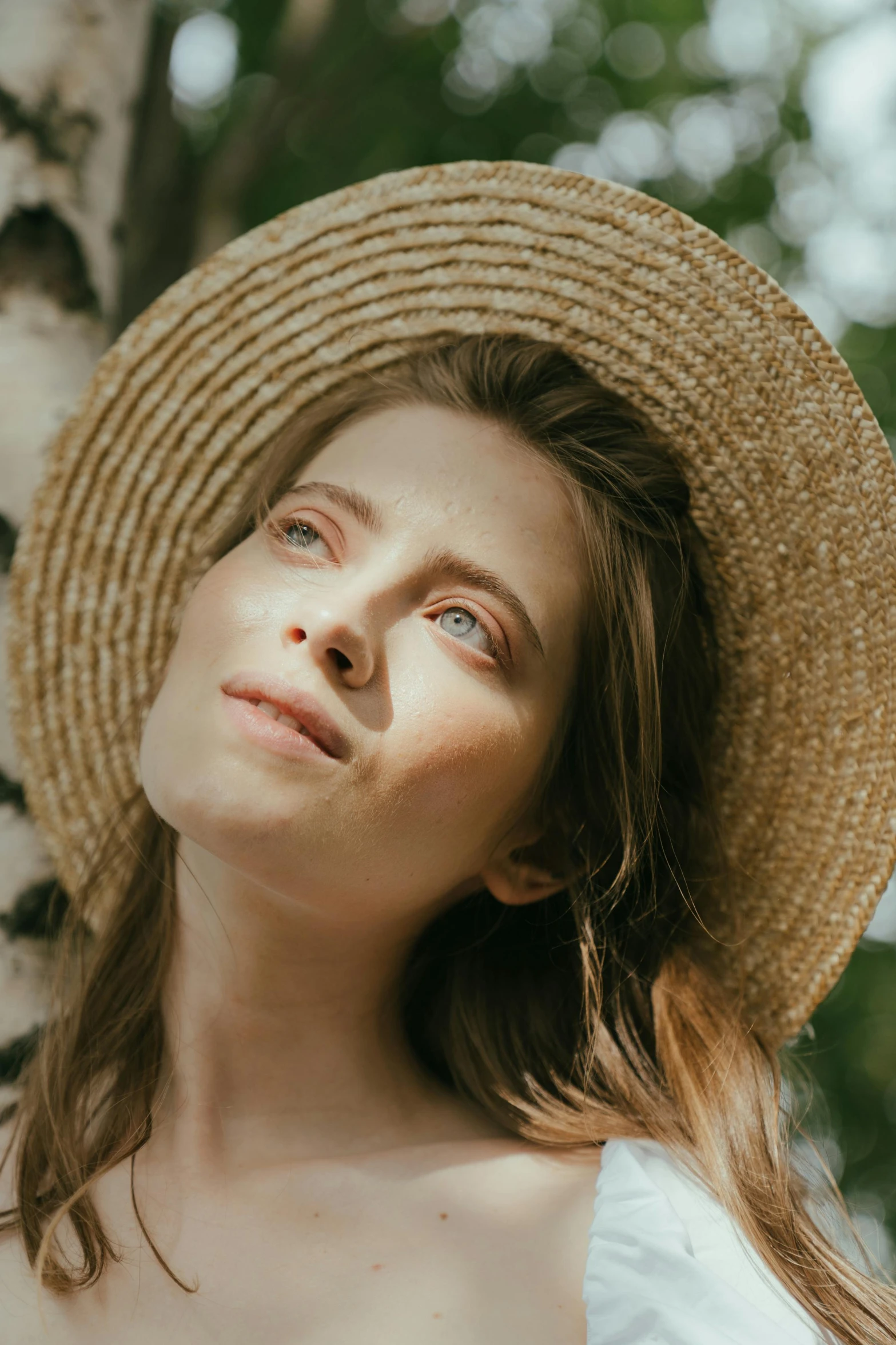 a beautiful young woman wearing a straw hat, by Anna Boch, pexels contest winner, renaissance, glowing skin face, head looking up, natural muted tones, beautiful nordic woman