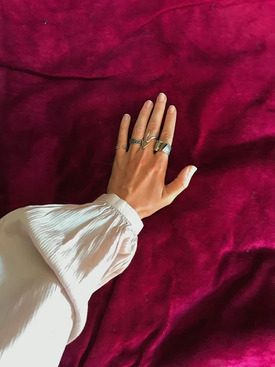 a close up of a person with a ring on their hand, an album cover, inspired by L. A. Ring, featured on instagram, hyperrealism, wearing dark silk robe, silver jewellery, 1997 ), moroccan queens ny