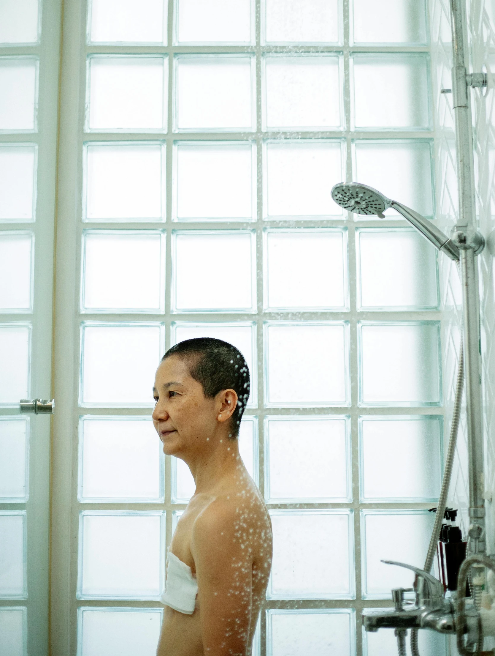 a woman taking a shower in a bathroom, by Katsukawa Shun'ei, unsplash, genderless, ignant, mariko mori, clean shaven