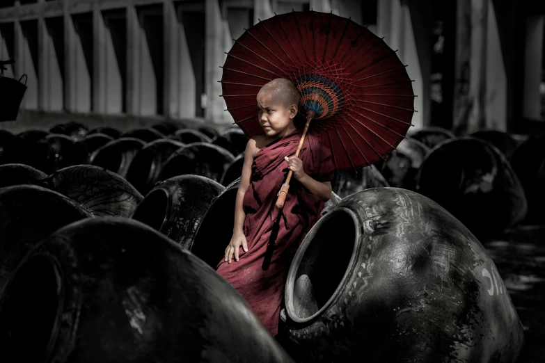 a monk sitting in a field with a red umbrella, 9 steel barrels in a graveyard, 5 0 0 px models, little kid, in a temple