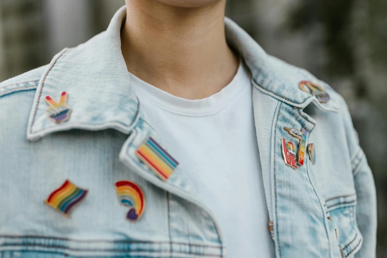 a close up of a person wearing a denim jacket, a cartoon, trending on pexels, rainbow accents, gay rights, beautiful clothes, federation clothing