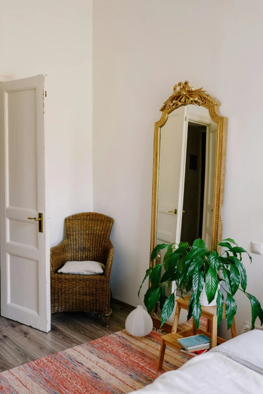 a bed room with a bed a chair and a mirror, a picture, inspired by Mihály Munkácsy, unsplash, balcony door, low quality photo, panorama, taken in the late 2000s