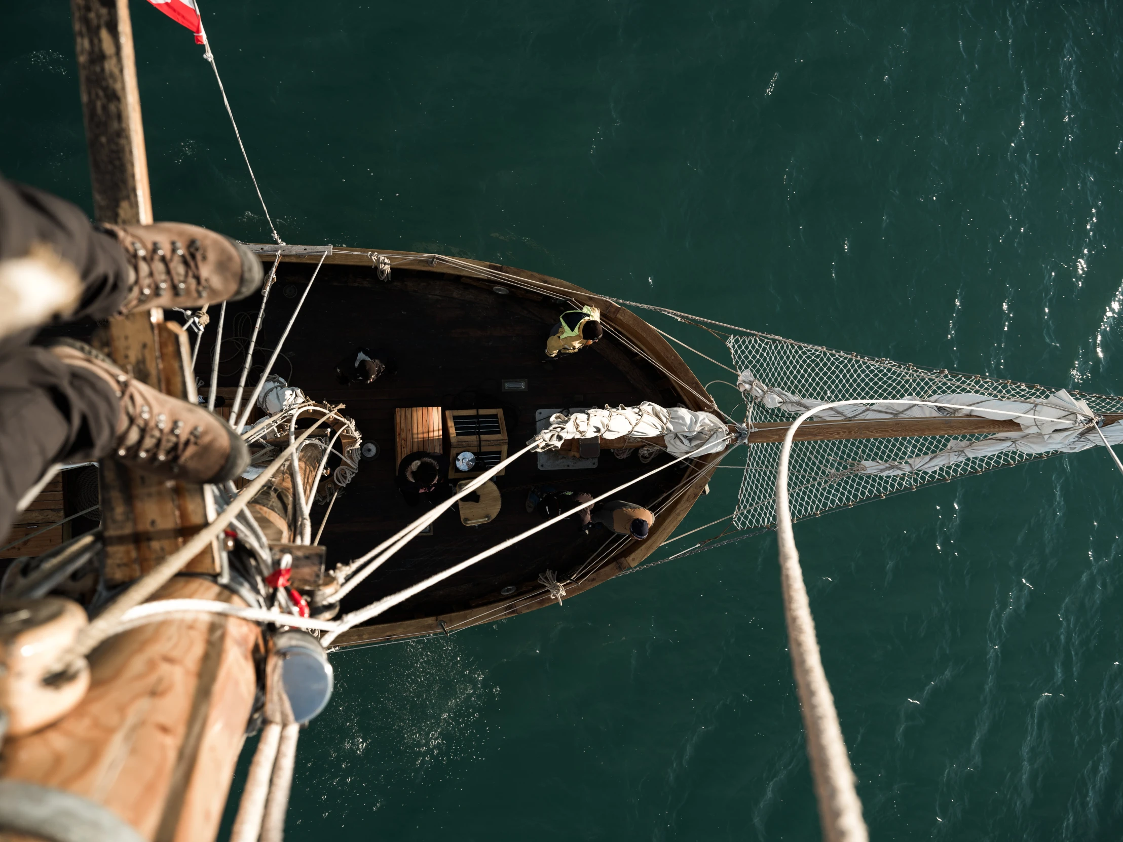 a man standing on top of a boat next to a body of water, by Simon Marmion, pexels contest winner, renaissance, game top down view, he's on an old sailing boat, as seen from the canopy, manly