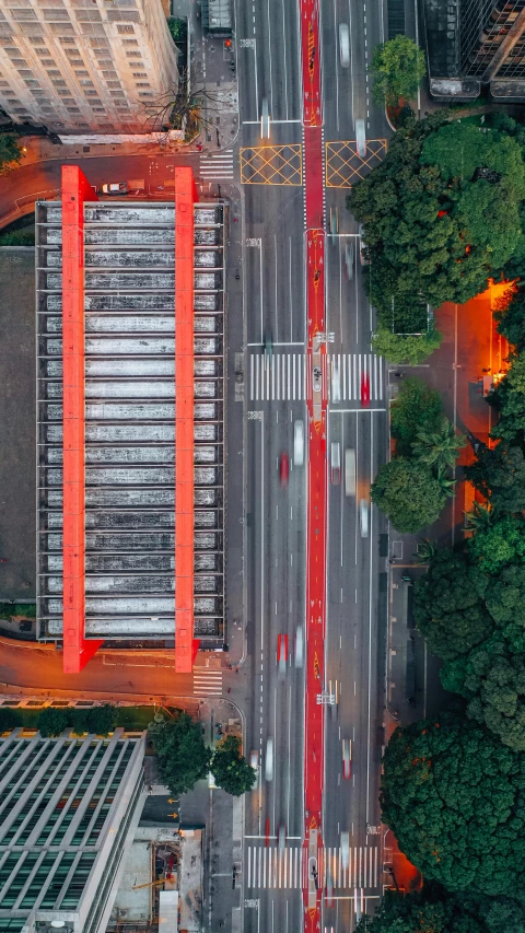 an aerial view of a city street at night, an album cover, inspired by Torii Kiyomoto, pexels contest winner, modernism, bus station, red trusses, mexico city, 8k detail