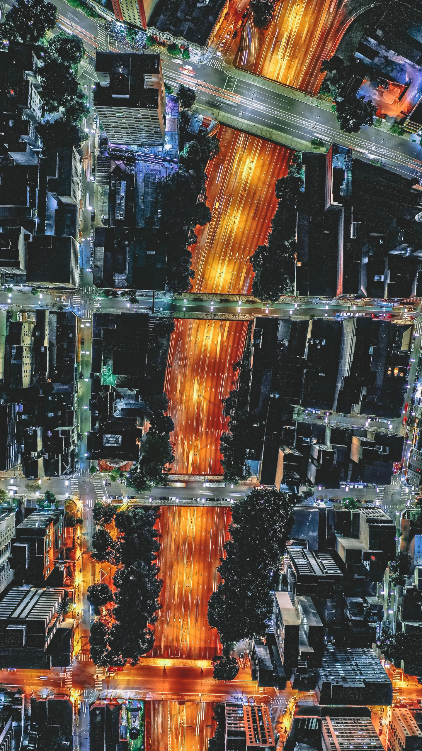 an aerial view of a city at night, an album cover, by Dan Scott, traffic lights, hypercomplex, closeup, orange lights