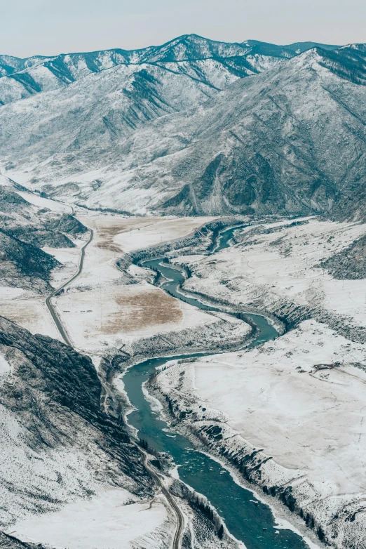 a river running through a snow covered valley, unsplash contest winner, hurufiyya, baotou china, helicopter view, panel, f / 2 0