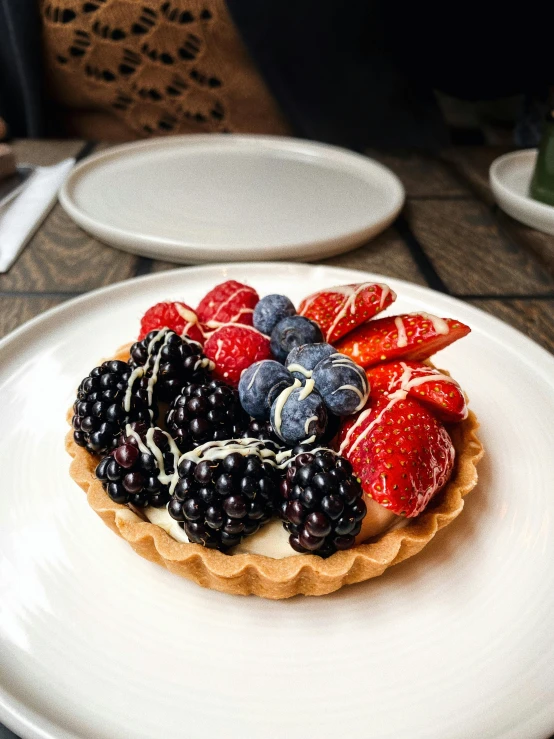 a close up of a plate of food on a table, berries, on a plate