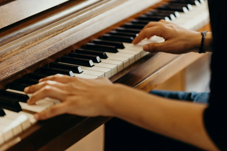 a close up of a person playing a piano, unsplash, jen atkin, lachlan bailey, schools, peaceful environment