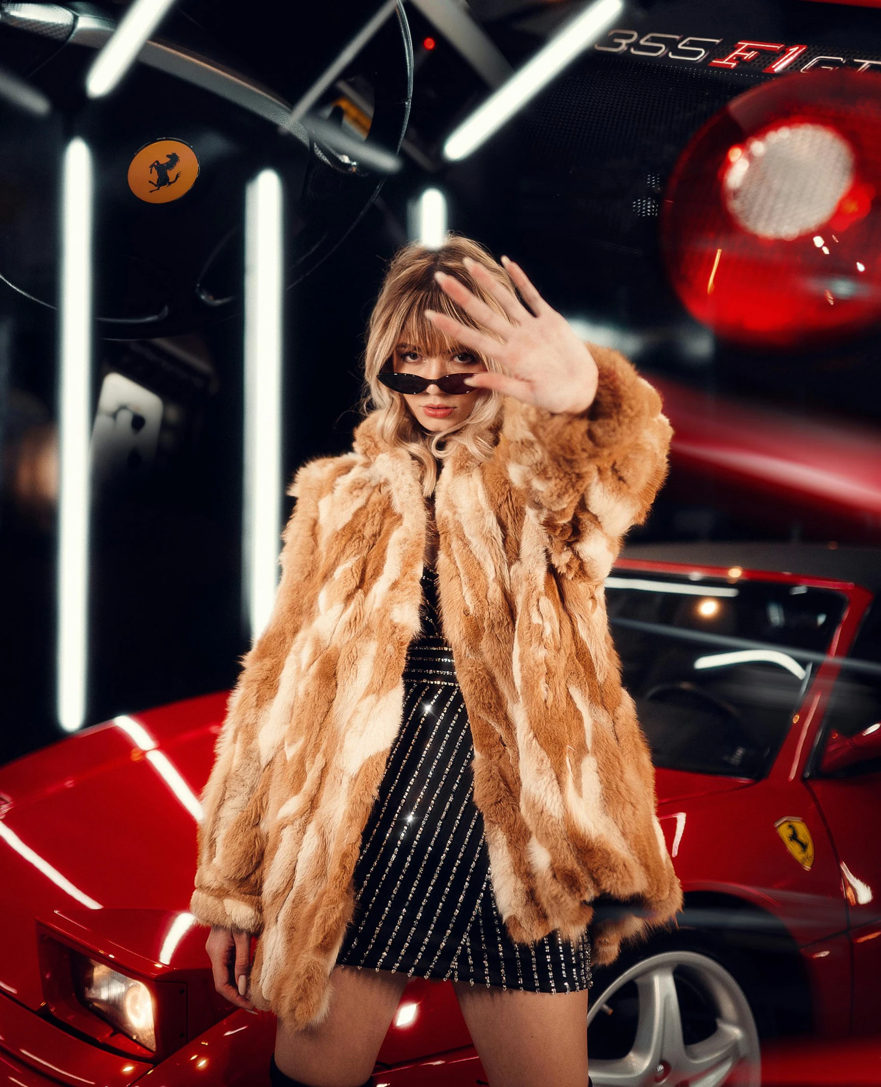 a woman standing in front of a red car, an album cover, inspired by Elsa Bleda, trending on pexels, fantastic realism, fur jacket, bad bunny, in an action pose, light brown fur
