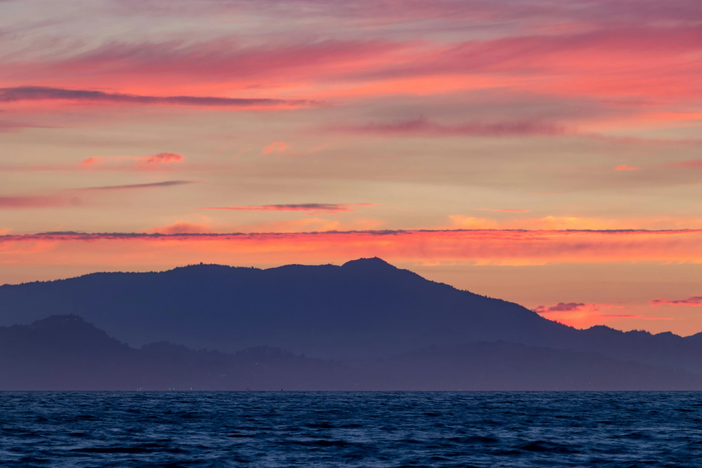 a large body of water with mountains in the background, by Doug Ohlson, pexels contest winner, romanticism, orange / pink sky, seaview, slide show, central california